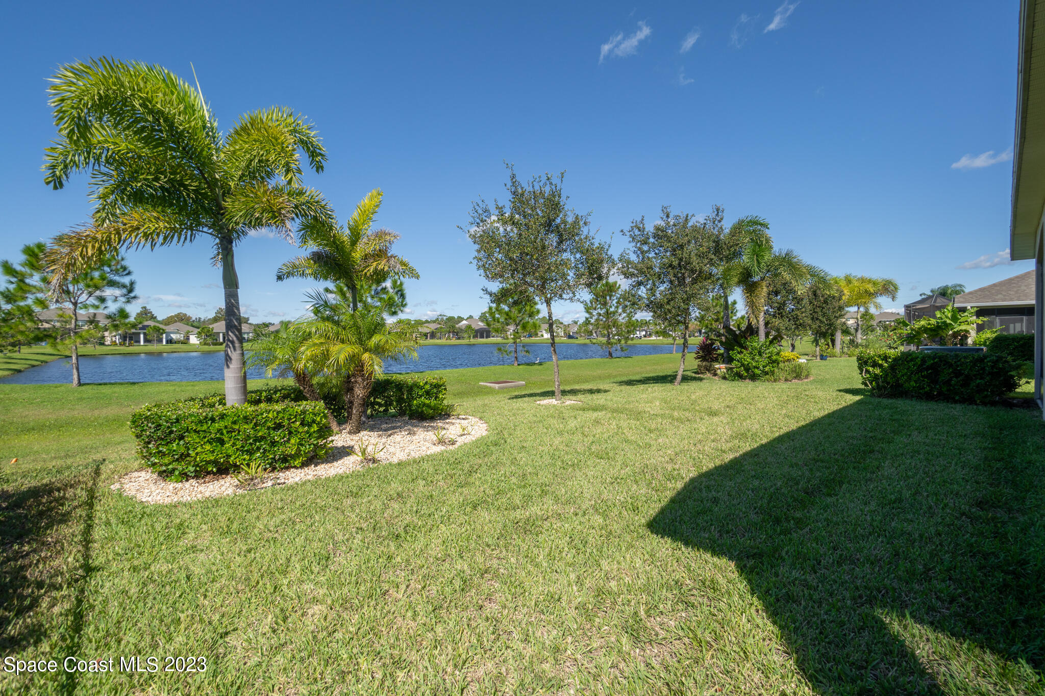 4465 Ruthann Circle Melbourne, FL 32934 - Photo 34 of 42 a view of a garden with a building in the background