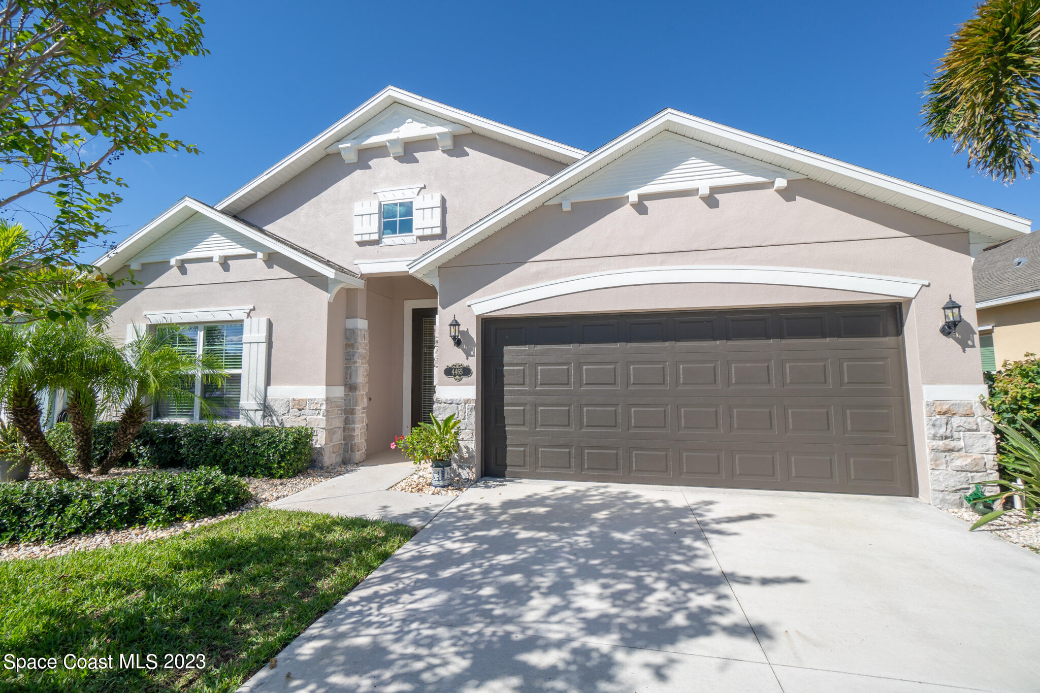 4465 Ruthann Circle Melbourne, FL 32934 - Photo 4 of 42 a front view of a house with a yard and garage