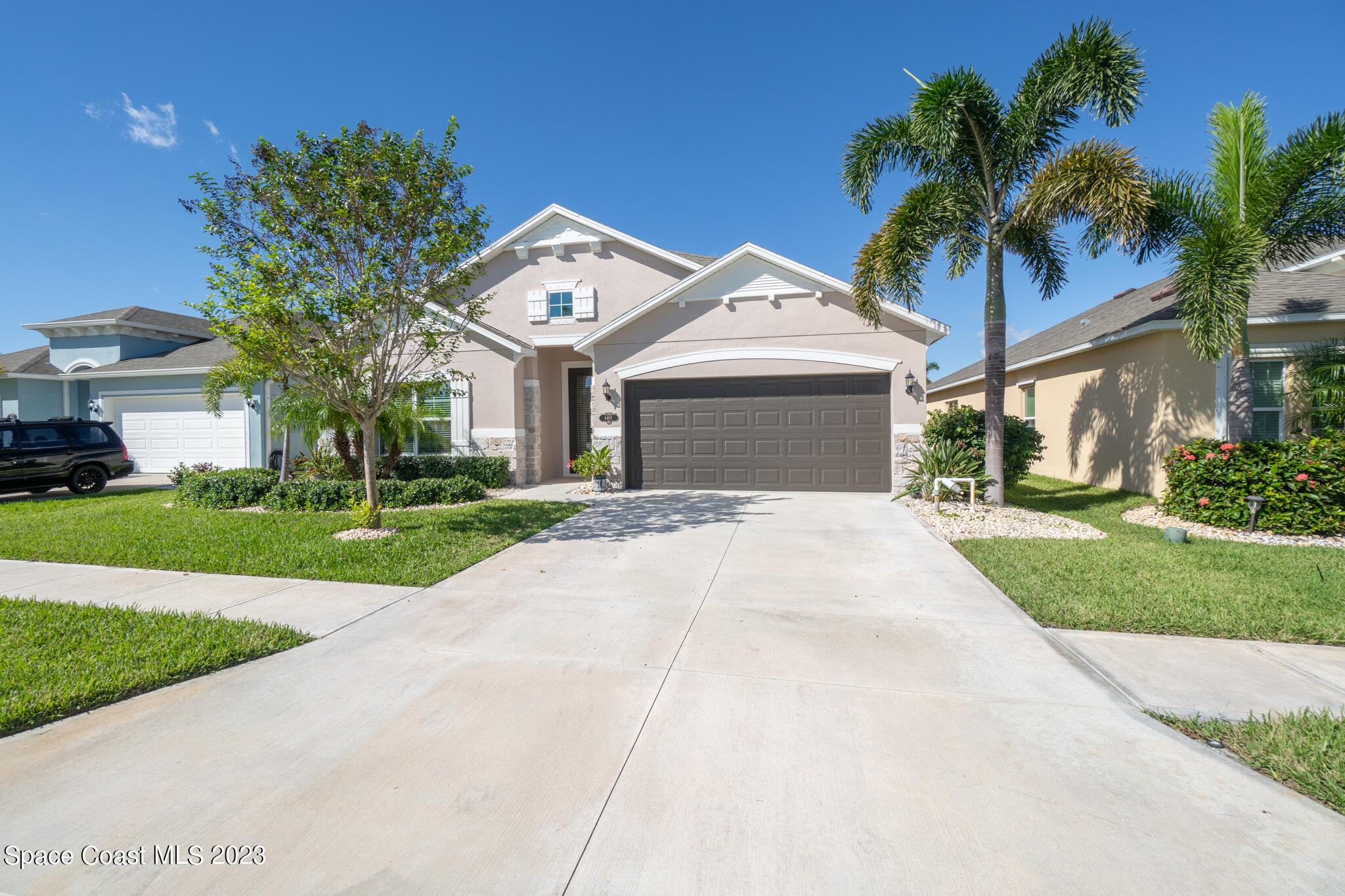 4465 Ruthann Circle Melbourne, FL 32934 - Photo 5 of 42 a front view of a house with a yard and garage