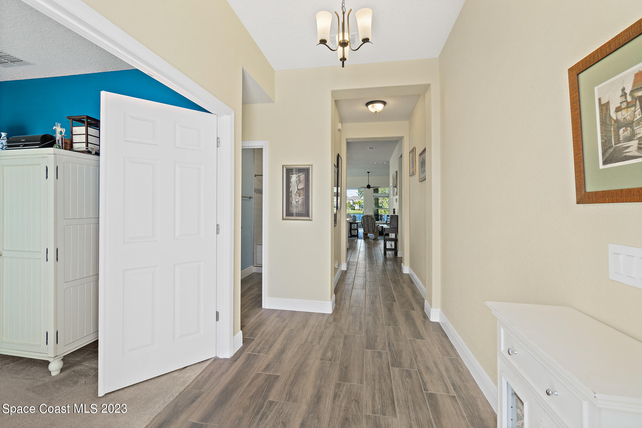 4465 Ruthann Circle Melbourne, FL 32934 - Photo 6 of 42 a view of a hallway view with wooden floor and staircase
