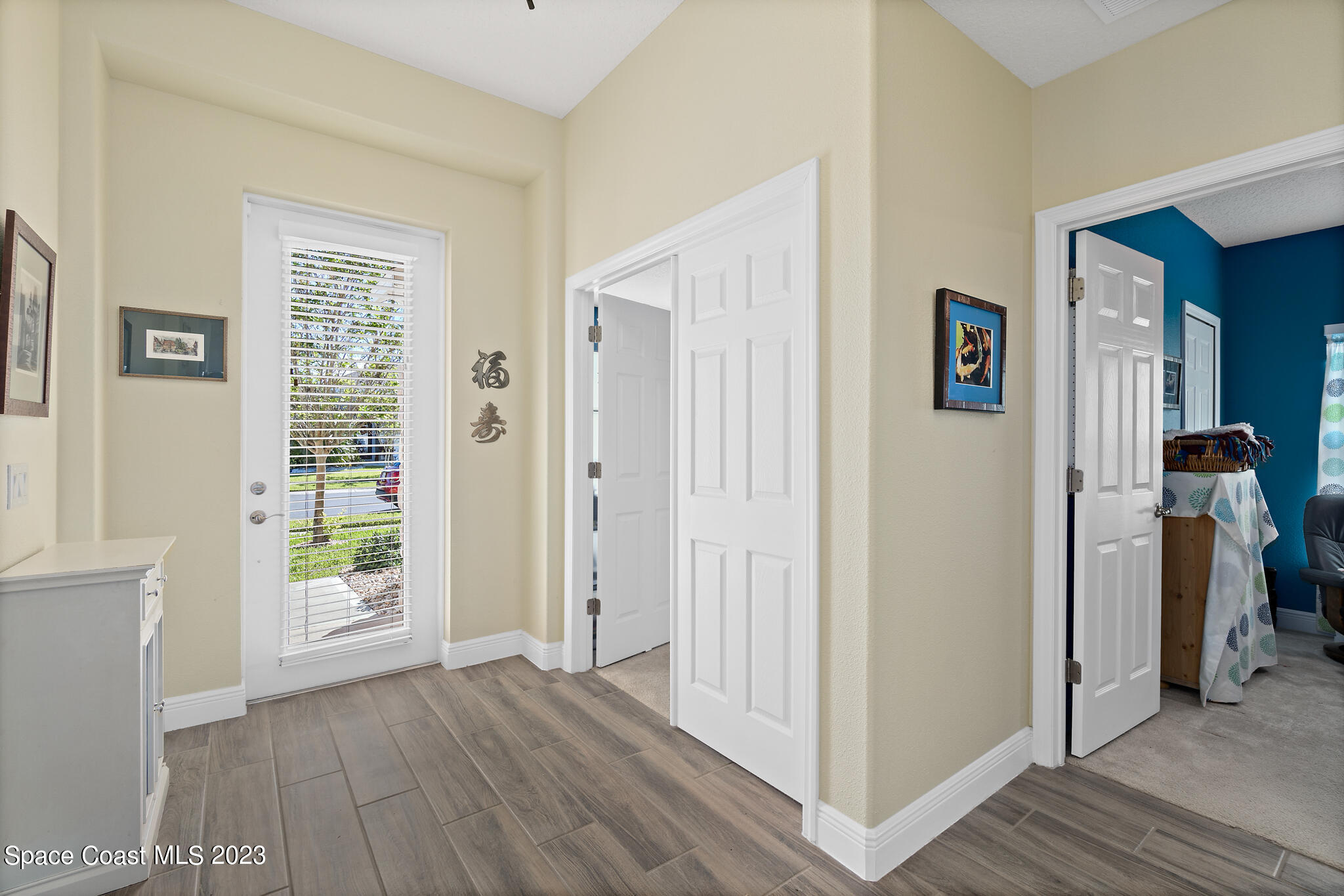 4465 Ruthann Circle Melbourne, FL 32934 - Photo 7 of 42 a view of an entryway with wooden floor and windows