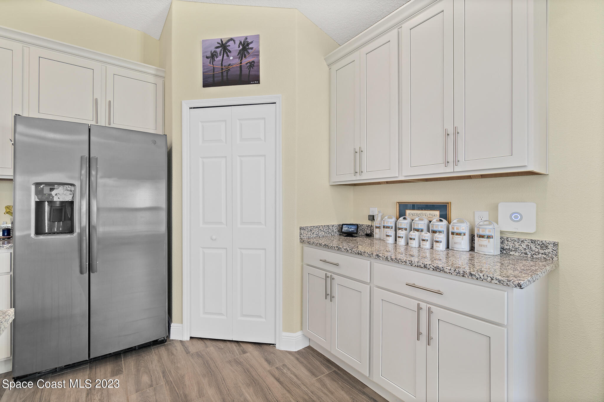4465 Ruthann Circle Melbourne, FL 32934 - Photo 10 of 42 a kitchen with stainless steel appliances granite countertop a refrigerator sink and white cabinets