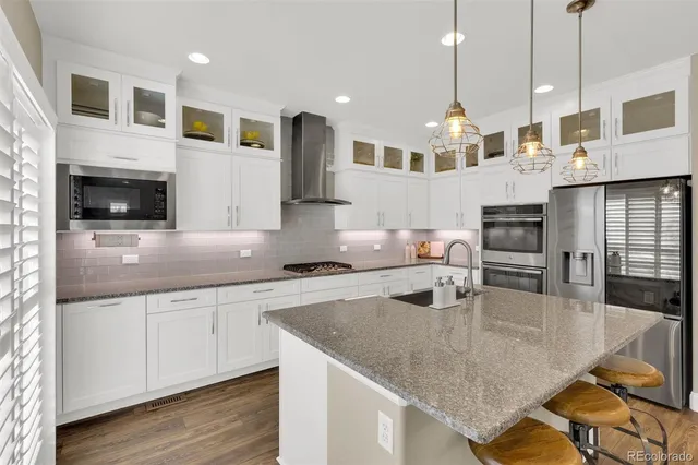 a kitchen with stainless steel appliances granite countertop a sink counter space and cabinets