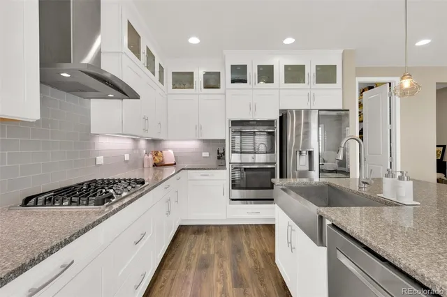 a kitchen with stainless steel appliances granite countertop a sink and stove