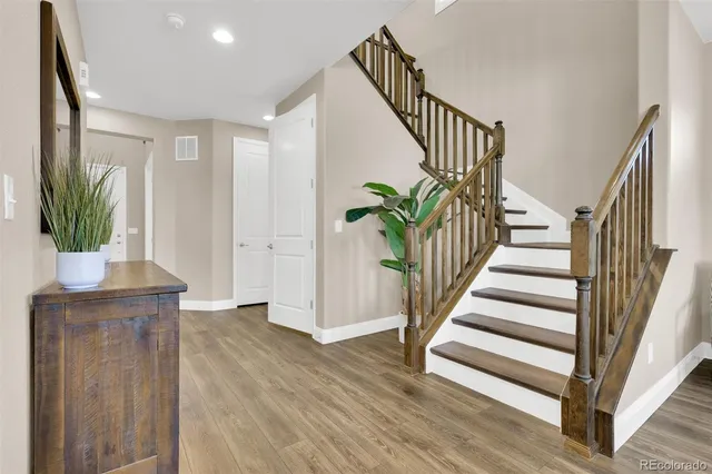 a view of entryway with wooden floor and stairs