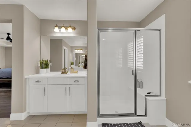 a bathroom with a sink a mirror and a shower