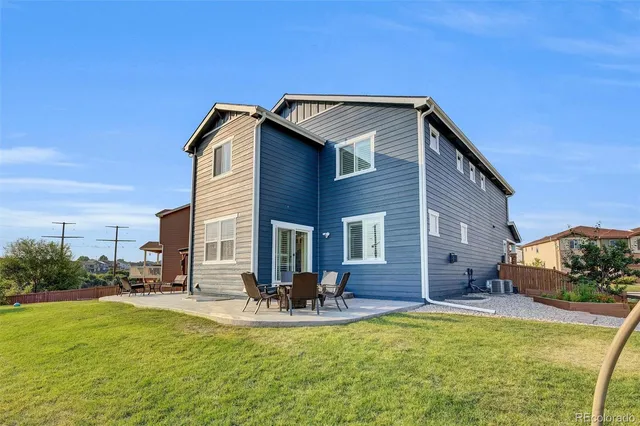 a view of a house with pool and chairs