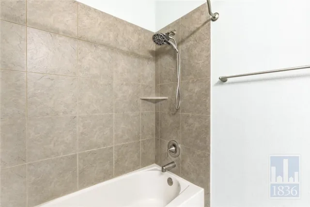 a bathroom with a bathtub and shower