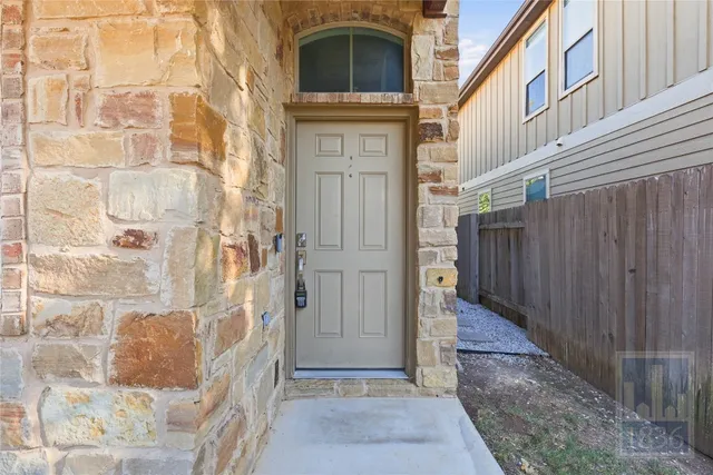 a view of a brick house with a door and a window