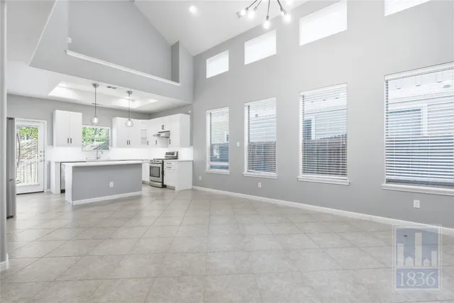 a kitchen with stainless steel appliances a refrigerator sink and stove
