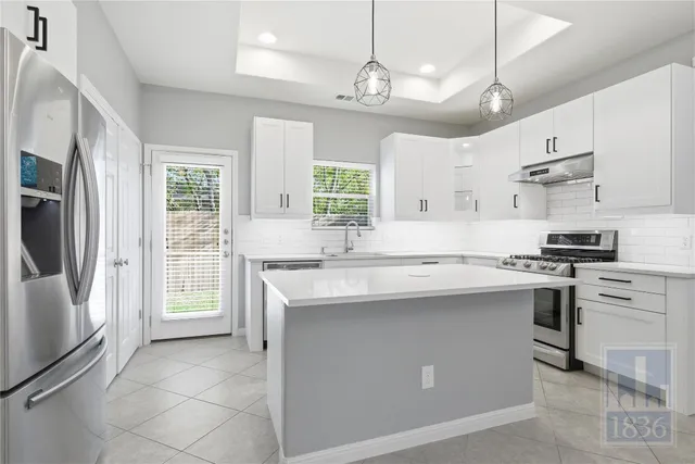 a kitchen with cabinets appliances and a sink