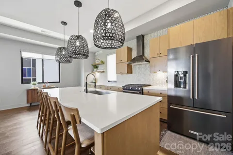 a kitchen with a table chairs and a refrigerator