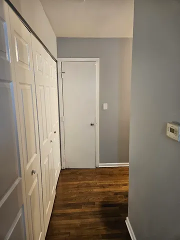 a view of room with wooden floor