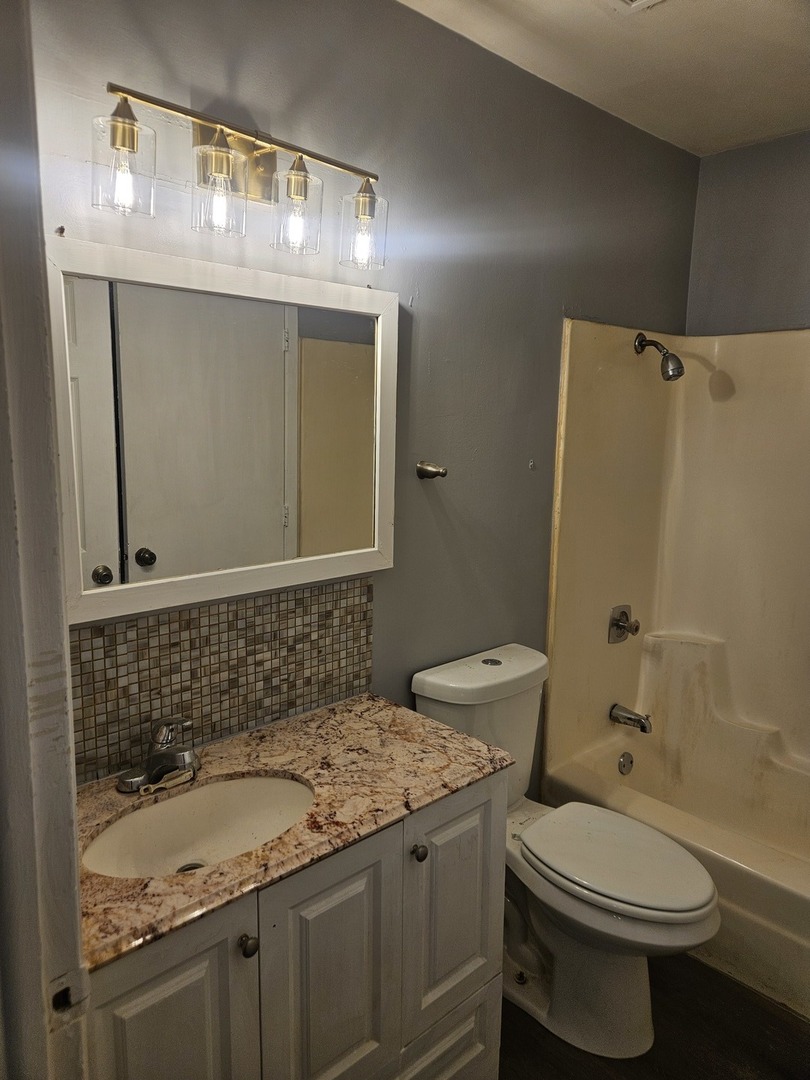 1612 Islandview Court Hoffman Estates, IL 60169 - Photo 15 of 15 a bathroom with a granite countertop sink toilet and shower