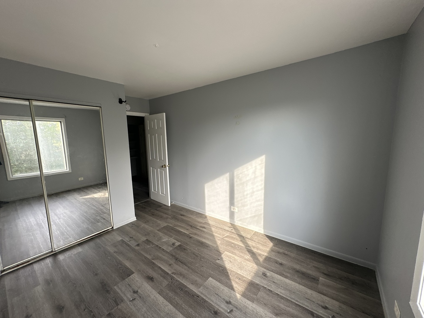 1612 Islandview Court Hoffman Estates, IL 60169 - Photo 2 of 15 a view of an empty room with window and wooden floor