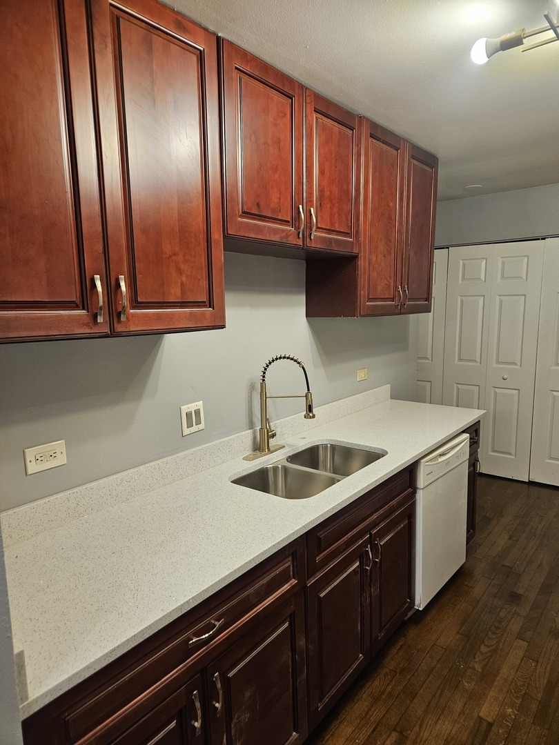 1612 Islandview Court Hoffman Estates, IL 60169 - Photo 7 of 15 a kitchen with granite countertop a sink and cabinets
