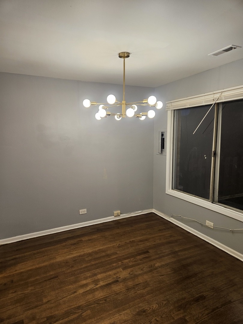 1612 Islandview Court Hoffman Estates, IL 60169 - Photo 10 of 15 a view of a room with wooden floor and chandelier