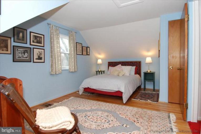 10403 Procter Street Silver Spring, MD 20901 - Photo 7 of 11 a bedroom with a bed and a window