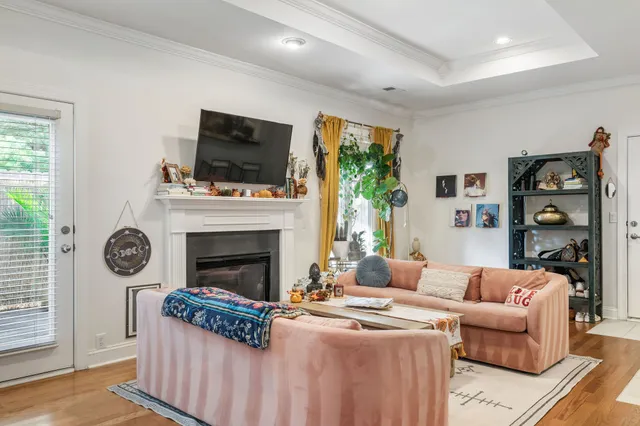 a living room with furniture a flat screen tv and a fireplace