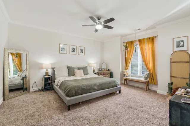 a spacious bedroom with a bed and a couch