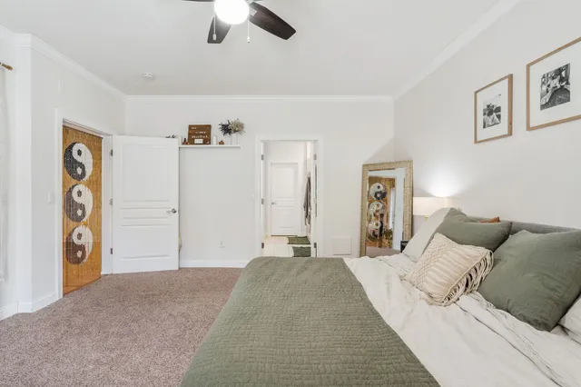 a bedroom with a large bed and a chandelier