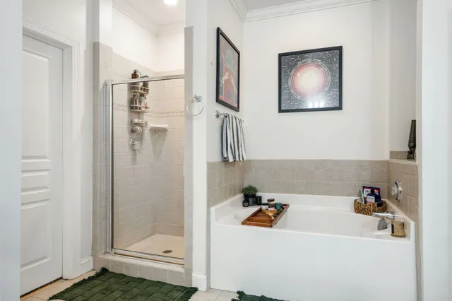 a bathroom with a tub a sink and mirror
