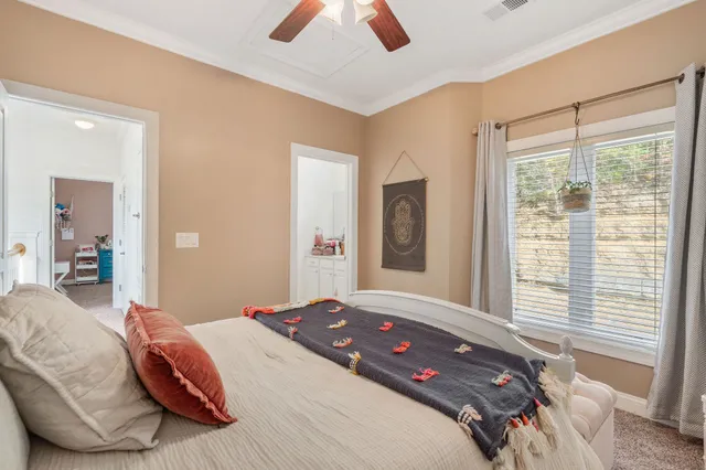 a bedroom with a bed and a large window