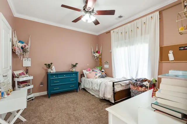 a bedroom with bed and window