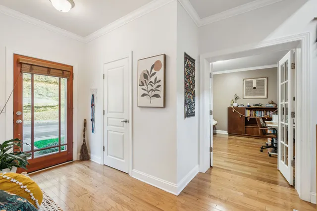 a view of a livingroom with wooden floor and a bedroom