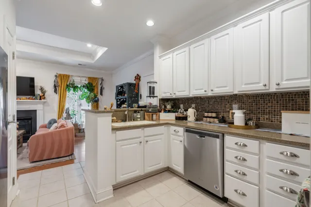 a kitchen with cabinets appliances a sink and a window