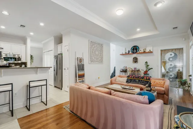 a living room with furniture and a kitchen view