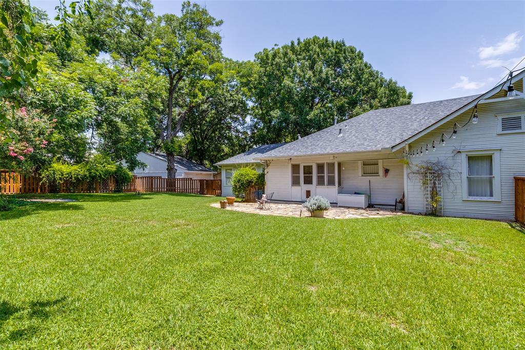 800 Harter Road Dallas, TX 75218 - Photo 11 of 17 Back of property featuring roof with shingles and a patio