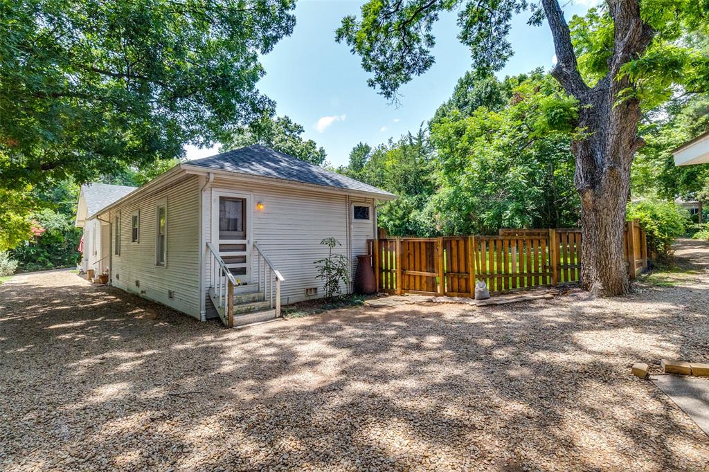 800 Harter Road Dallas, TX 75218 - Photo 12 of 17 Back of house featuring crawl space, a shingled roof, and entry steps
