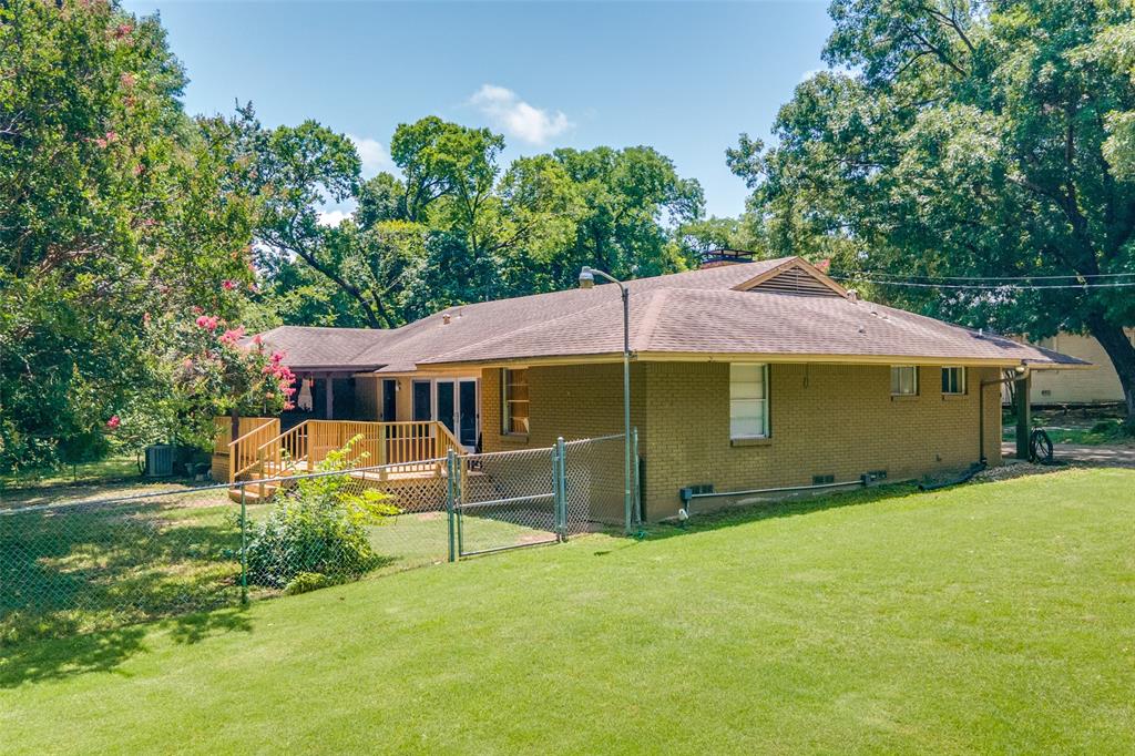 800 Harter Road Dallas, TX 75218 - Photo 5 of 17 Back of property featuring a gate, roof with shingles, brick siding, a deck, and a chimney