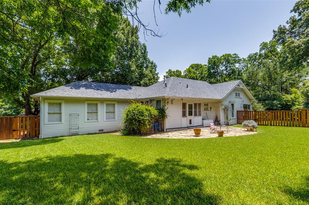 800 Harter Road Dallas, TX 75218 - Photo 7 of 17 Rear view of property featuring a patio area, a fenced backyard, roof with shingles, and crawl space