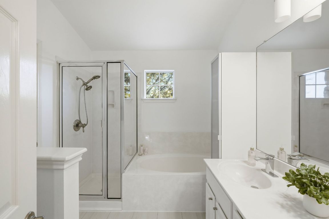 1900 Scofield Ridge Parkway, Unit 203 Austin, TX 78727 - Photo 19 of 31 Bathroom with vanity, a garden tub, and a shower stall