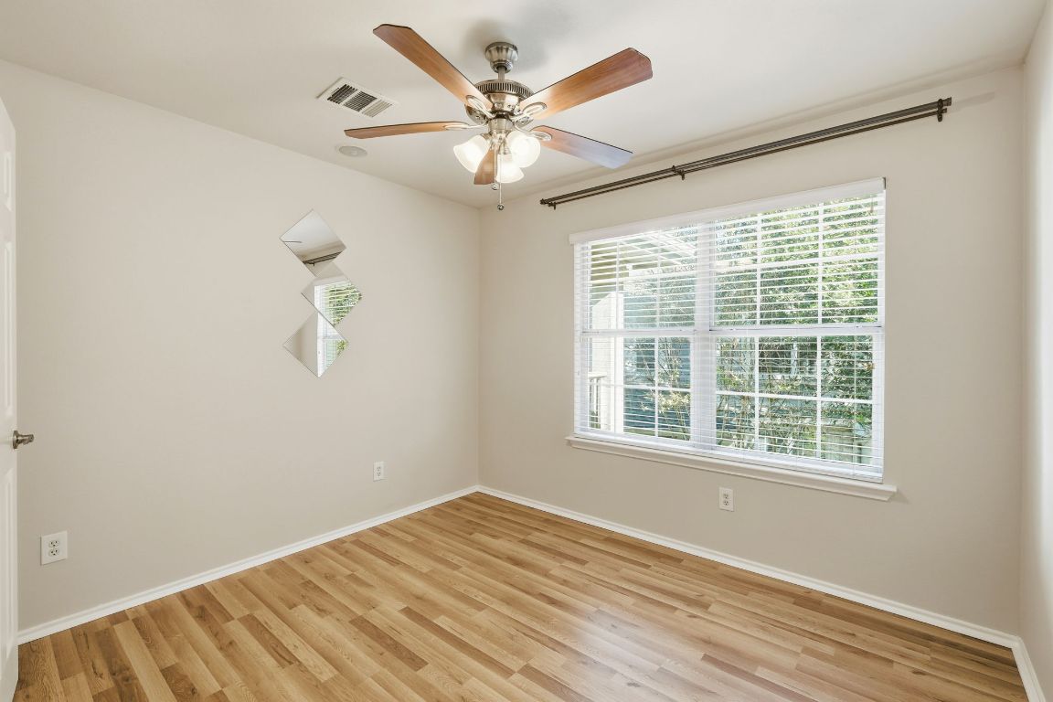 1900 Scofield Ridge Parkway, Unit 203 Austin, TX 78727 - Photo 20 of 31 Spare room with light wood finished floors and a ceiling fan