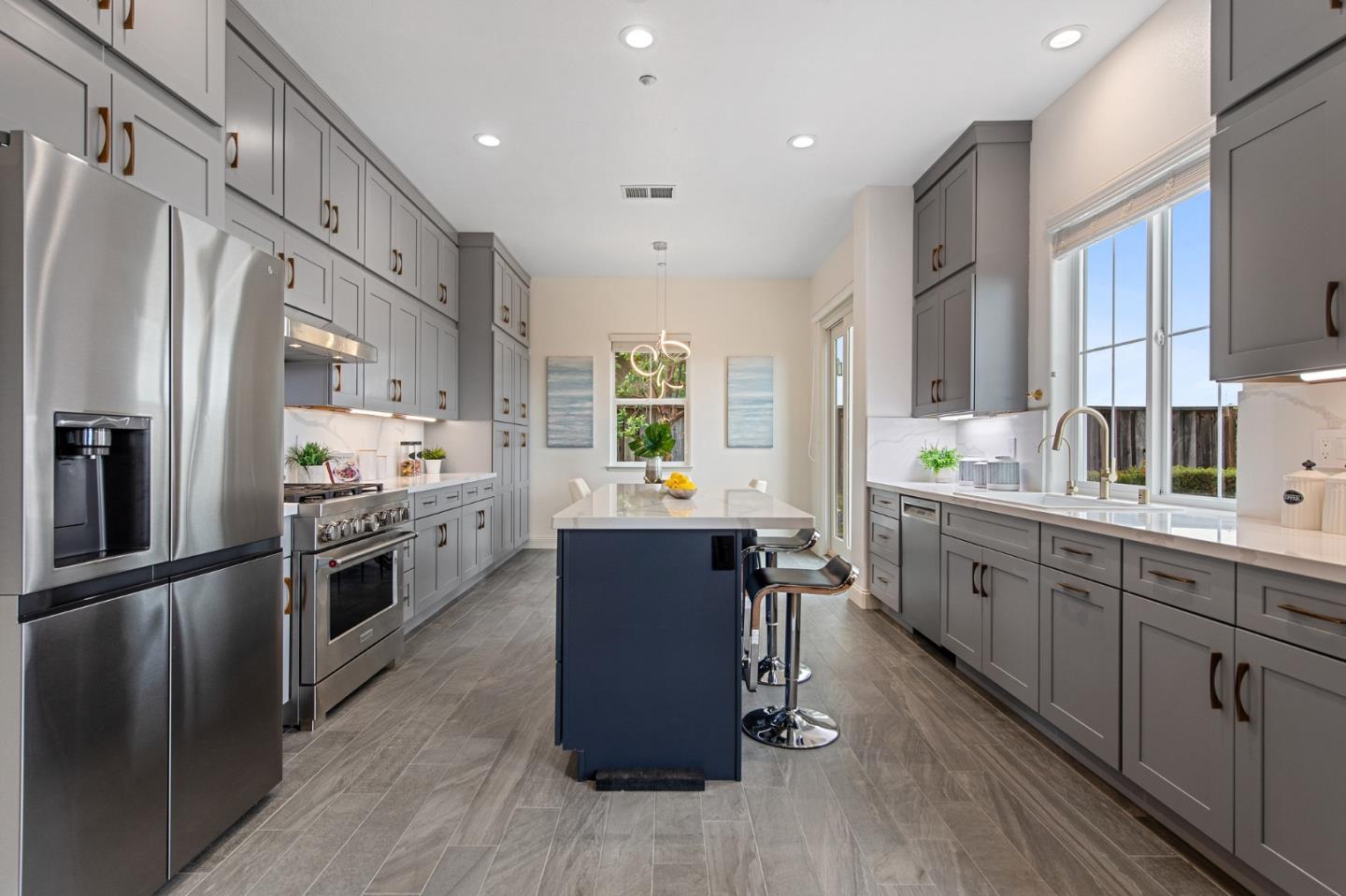 9 Estates Drive Millbrae, CA 94030 - Photo 15 of 52 a kitchen with stainless steel appliances granite countertop a refrigerator a sink dishwasher a stove and white countertops with wooden floor
