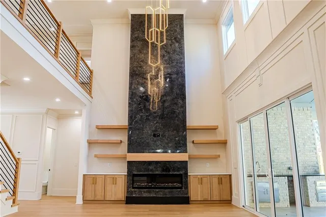 a view of an empty room with a fireplace and a window