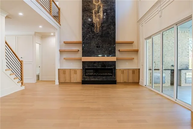 a view of a livingroom with wooden floor and a fireplace