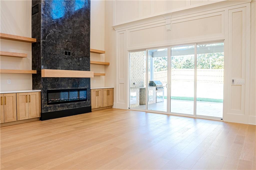 2210 Ridgedale Drive Southwest Grayson, GA 30017 - Photo 16 of 74 a view of an empty room with wooden floor fireplace and a window
