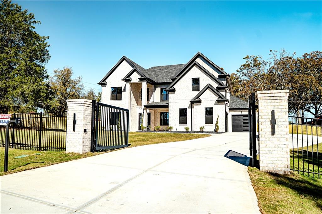 2210 Ridgedale Drive Southwest Grayson, GA 30017 - Photo 2 of 74 a view of a white house with wooden fence