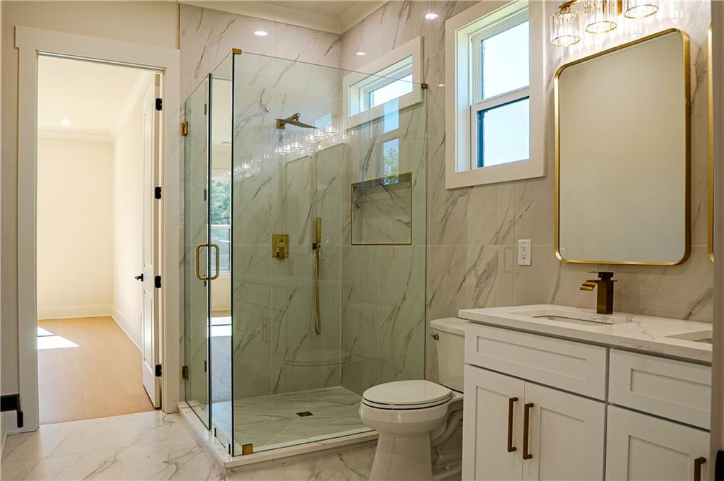 2210 Ridgedale Drive Southwest Grayson, GA 30017 - Photo 47 of 74 a bathroom with a shower sink vanity and toilet
