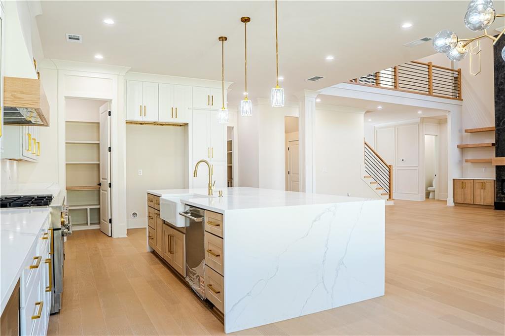 2210 Ridgedale Drive Southwest Grayson, GA 30017 - Photo 9 of 74 a large kitchen with stainless steel appliances kitchen island granite countertop a refrigerator a oven and a wooden floors