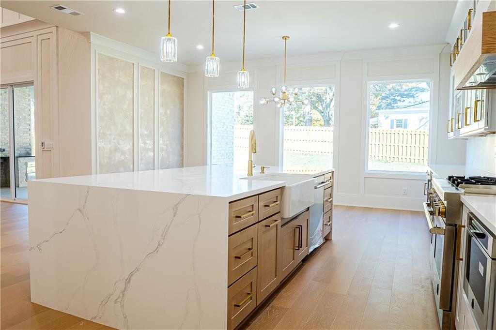 2210 Ridgedale Drive Southwest Grayson, GA 30017 - Photo 10 of 74 a kitchen with stainless steel appliances granite countertop a stove a sink and a refrigerator with wooden floor