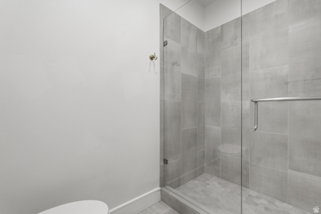 653 East Vandalay Lane Draper, UT 84020 - Photo 35 of 61 Tiled shower enclosure featuring a clear glass door, chrome hardware, and hexagonal floor tiles