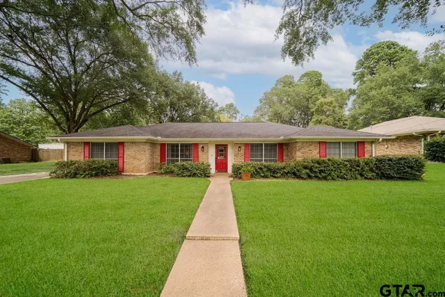 a front view of a house with yard