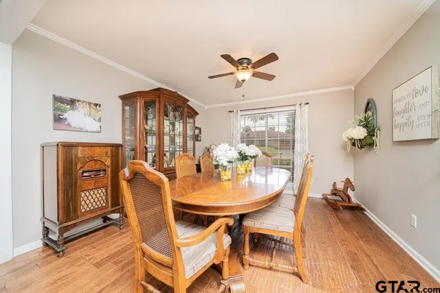a view of a dining room with furniture and a chandelier