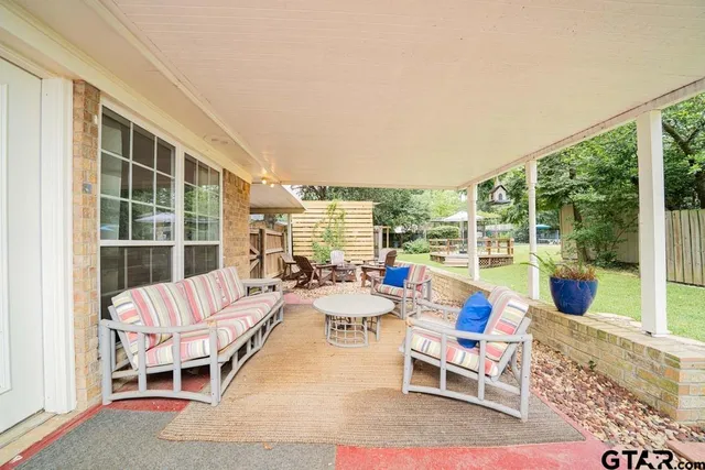 a room with patio furniture and a large window