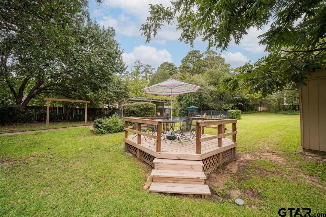 607 Green Oak Drive Longview, TX 75604 - Photo 28 of 48 a view of a swimming pool with a garden